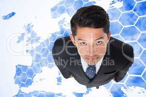 Composite image of serious asian businessman