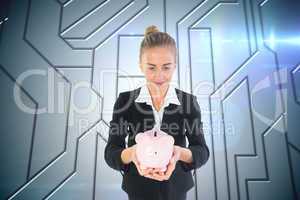 Composite image of businesswoman holding pink piggy bank