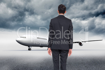 Composite image of businessman turning his back to camera