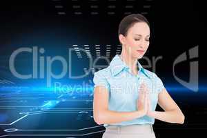 Composite image of peaceful young businesswoman praying