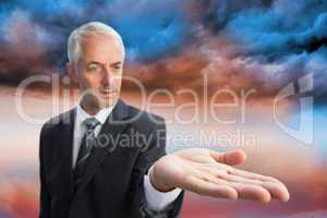 Composite image of concentrated businessman with palm up