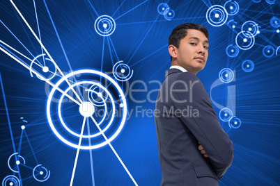 Composite image of unsmiling asian businessman with arms crossed