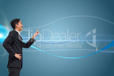 Composite image of smiling asian businessman pointing