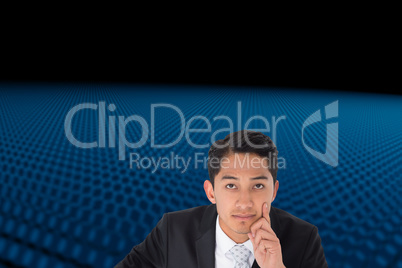 Composite image of thoughtful asian businessman pointing