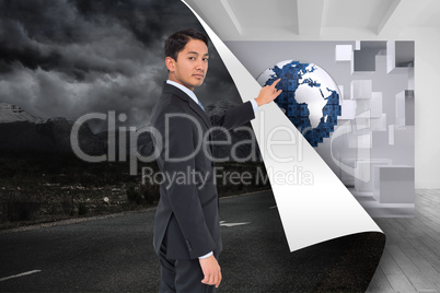 Composite image of serious asian businessman pointing