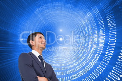 Composite image of smiling asian businessman with arms crossed