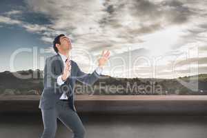 Composite image of unsmiling businessman catching