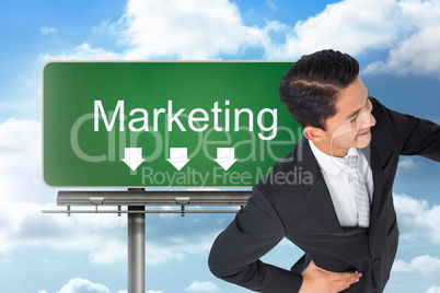 Composite image of smiling asian businessman pointing