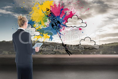 Composite image of businesswoman holding new tablet