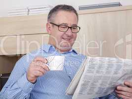 man reading the newspaper in his spare time