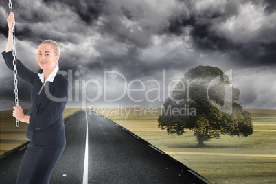 Composite image of businesswoman pulling a chain