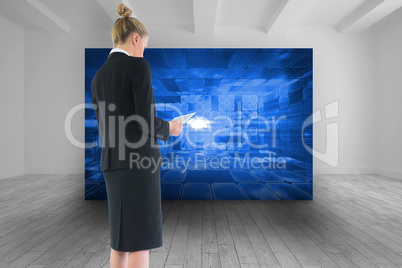 Composite image of businesswoman holding new tablet