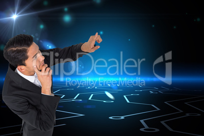 Composite image of thoughtful asian businessman pointing