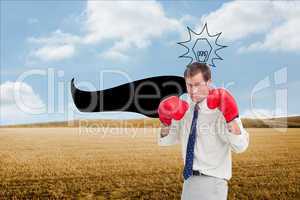 Composite image of businessman with his boxing gloves ready to f