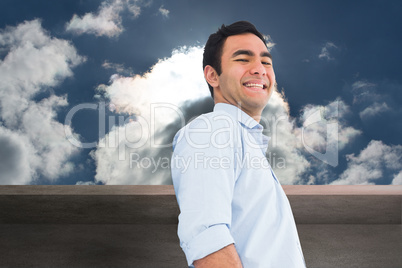 Composite image of smiling casual man standing