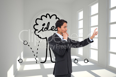 Composite image of thoughtful asian businessman pointing