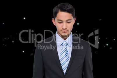 Composite image of serious asian businessman