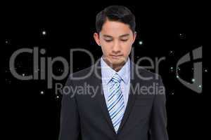 Composite image of serious asian businessman