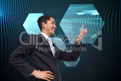 Composite image of smiling asian businessman pointing