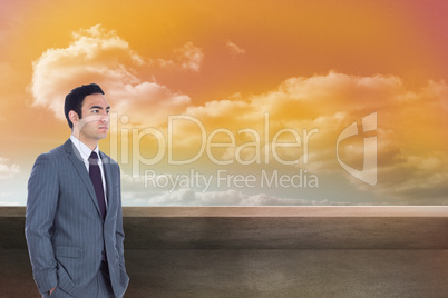 Composite image of unsmiling businessman standing