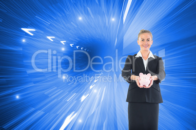 Composite image of happy businesswoman holding a piggy bank