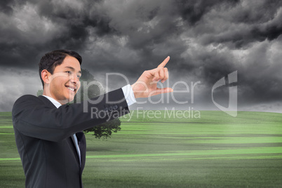 Composite image of smiling asian businessman pointing