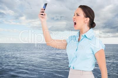 Composite image of angry classy businesswoman yelling at her sma