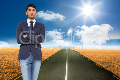 Composite image of unsmiling casual businessman with arms crosse