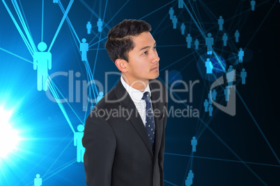 Composite image of serious asian businessman