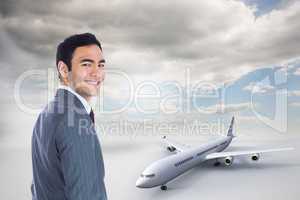 Composite image of smiling businessman standing