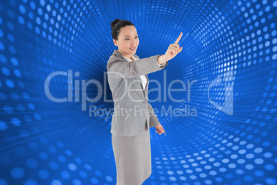 Composite image of smiling asian businesswoman pointing