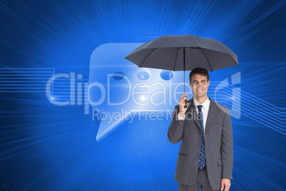 Composite image of happy businessman holding grey umbrella