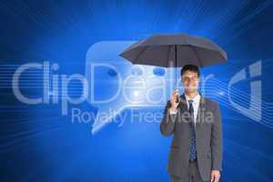 Composite image of happy businessman holding grey umbrella