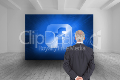 Composite image of rear view of serious businessman posing