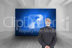 Composite image of rear view of serious businessman posing