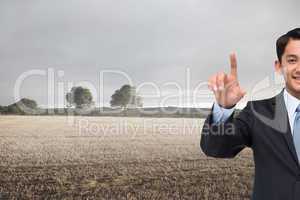 Composite image of smiling asian businessman pointing