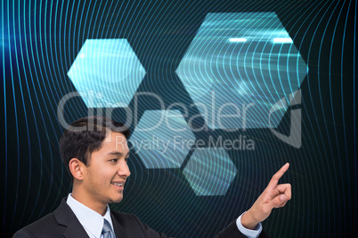 Composite image of smiling asian businessman pointing