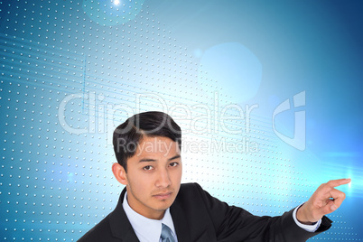 Composite image of unsmiling asian businessman pointing