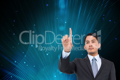 Composite image of serious asian businessman pointing