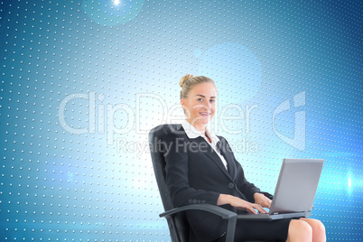 Composite image of businesswoman sitting in swivel chair with la