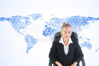 Composite image of businesswoman sitting on swivel chair with la