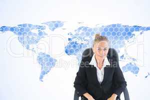 Composite image of businesswoman sitting on swivel chair with la