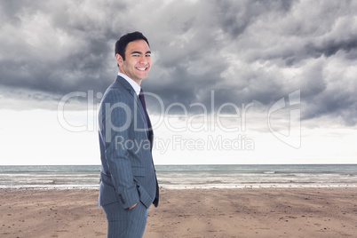 Composite image of smiling businessman standing