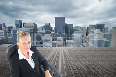 Composite image of businesswoman sitting on swivel chair with la