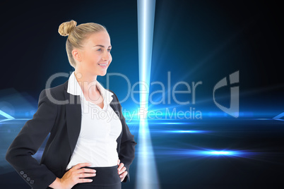 Composite image of businesswoman standing with hands on hips