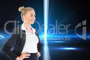 Composite image of businesswoman standing with hands on hips