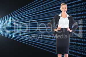 Composite image of businesswoman standing with hands on hips