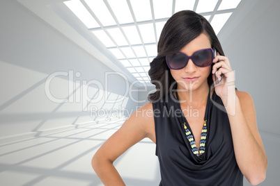 Composite image of serious elegant brunette wearing sunglasses o