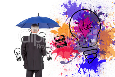 Composite image of businessman holding umbrella