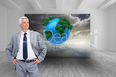 Composite image of man in a suit with his hands on his hips